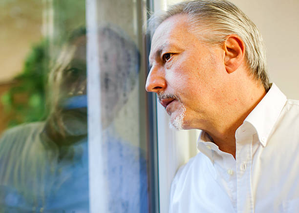 istock Senior manager looking outside the window from his office 504068970