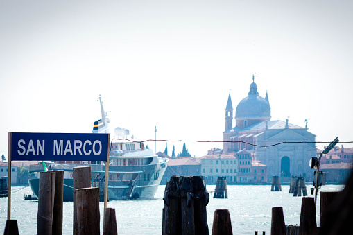 Small cruise ship on Venice Lagoon with San Giorgio Maggiore in the background.