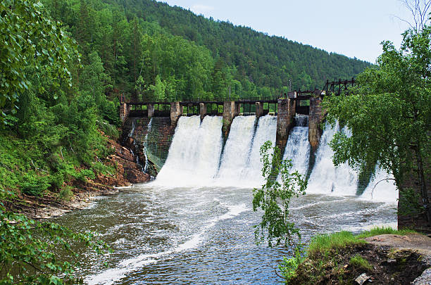 плотины является гидроэлектростанция - flowing river water dam стоковые фото и изображения