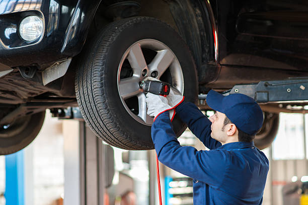 istock Portrait of a mechanic replacing wheel 504070478