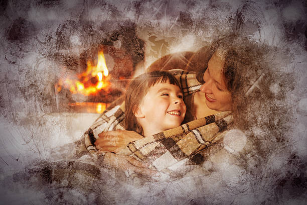 istock Mother and daughter sitting by the fireplace 504070668