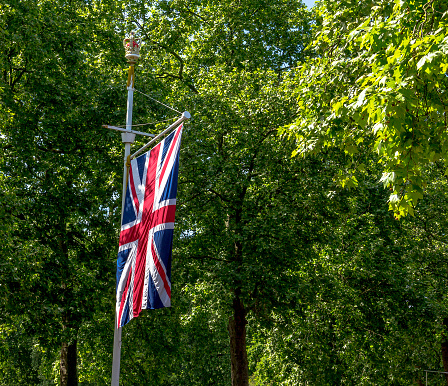 London. UK - June 4, 2015: The Union Jack Flag flying from a flag pole on The Mall street. 
