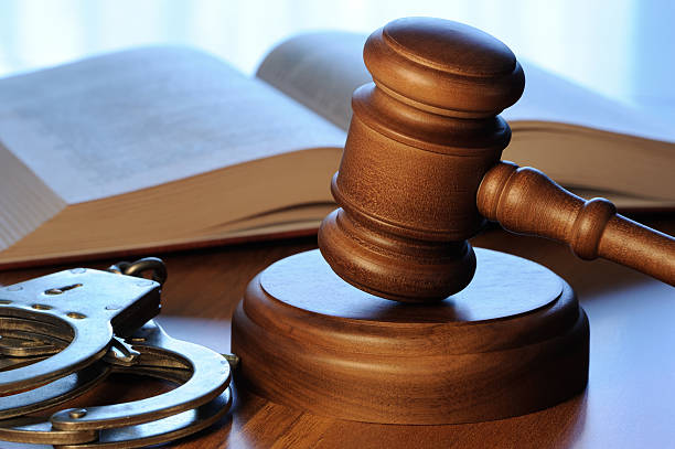 Gavel, book and handcuffs stock photo