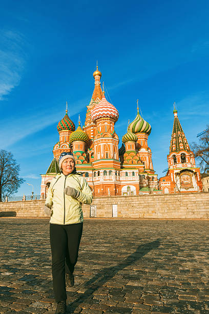 istock Active Mature Woman Running, St Basils Cathedral, Moscow, Russia 504076502
