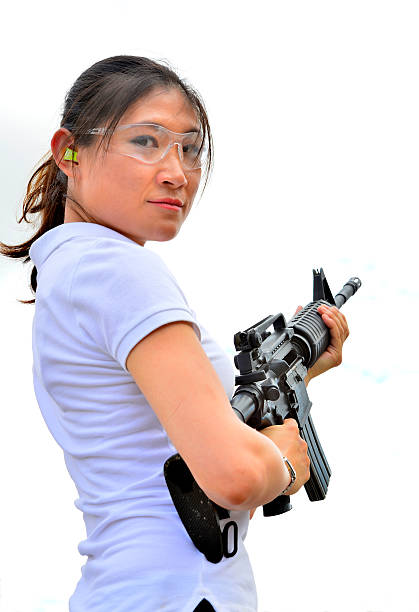 istock Military woman pointing her gun 504077391