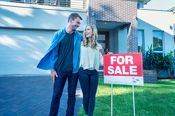 istock Couple standing in front of a new home. 504077510