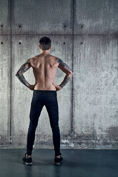 istock Fit sportive muscular man stands back to camera 504080054
