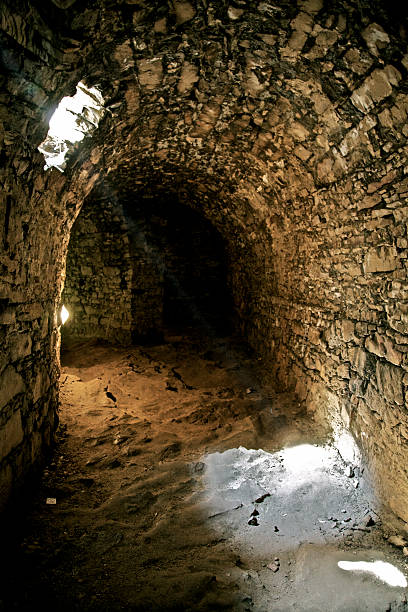 istock Dungeon basement cave dark room light beam old medieval cellar 504080692