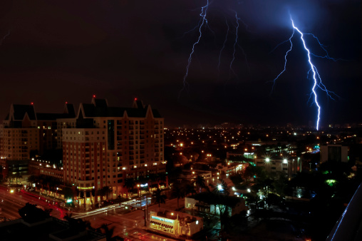 Fort Lauderdale, USA - February 8, 2007: An ominous thunderstorm with a lightning bolt striking over Fort Lauderdale late at night along North Federal Highway on a warm summer night.  
