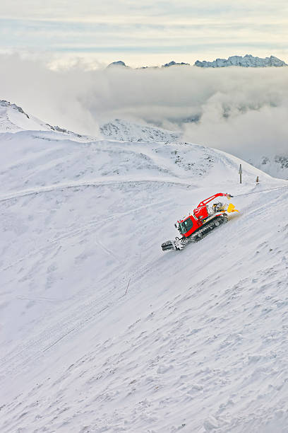 Group of snow groomers - snowcat ratracks machine at Alps resort in France prepare ski tracks