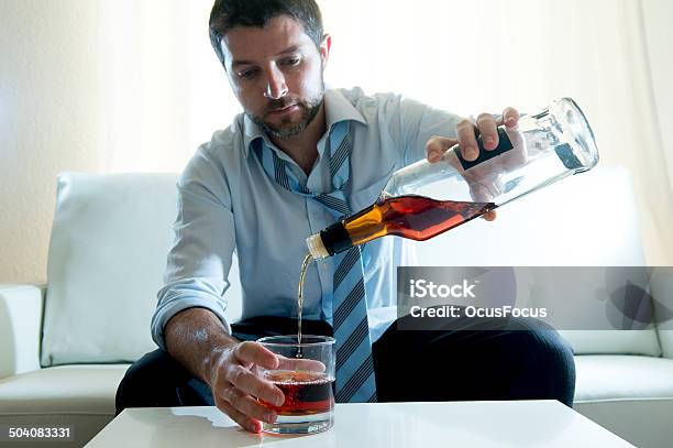 Businessman Wearing Blue Shirt Drunk At Desk On White Background Stock Photo - Download Image Now