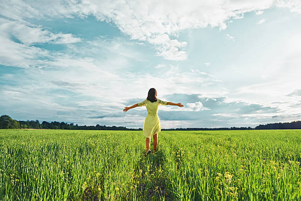 istock Woman in a green field 504083667