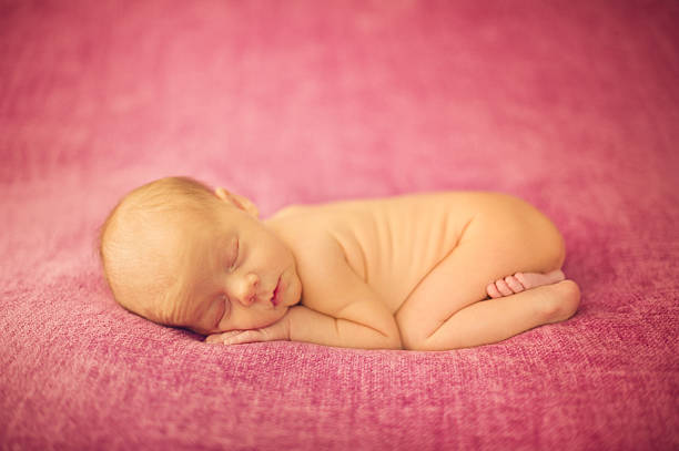istock Dreaming Naked Newborn Sleeping 504084199