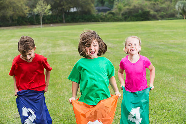 istock Three children having fun competing in potato sack race 504086640