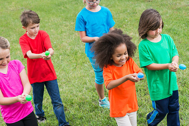 istock Group of children in egg spoon race 504086668