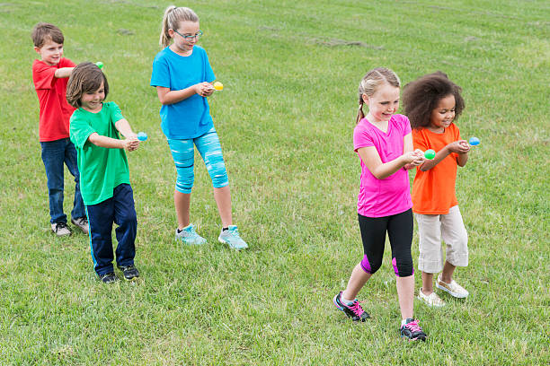 istock Group of children in egg spoon race 504086686