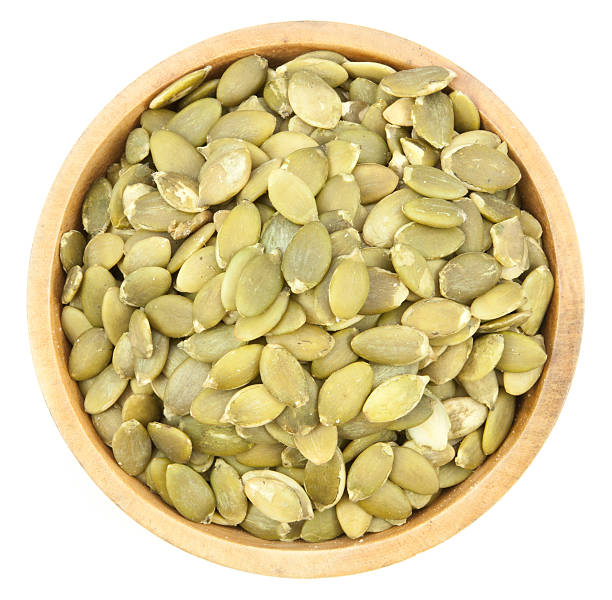 istock Pumpkin Seeds in a wood bowl 504098330