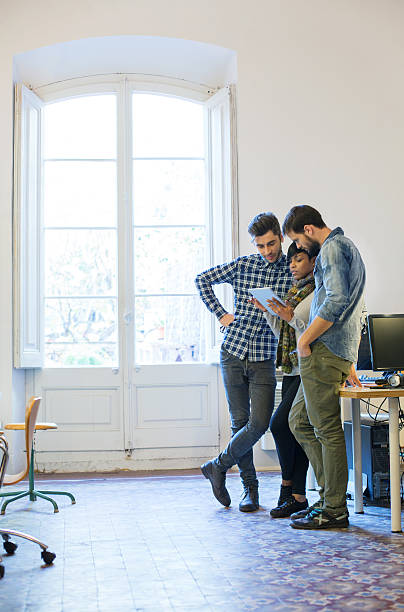 istock Young people discussing new project in office 504098418