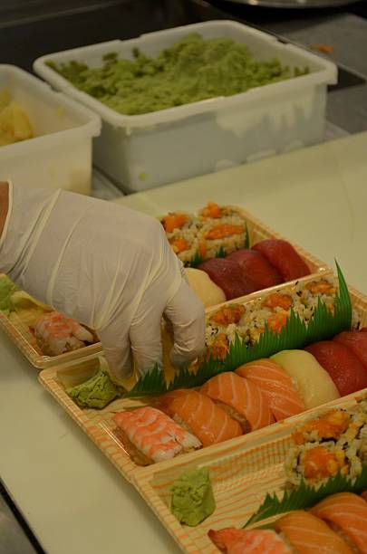 istock Chef Puts Sushi in Takeout Containers 504098574