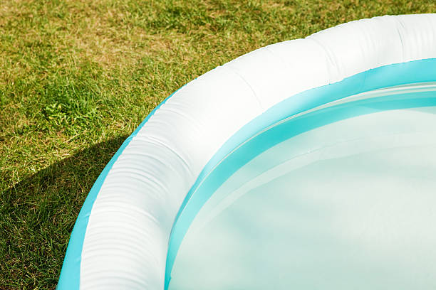 istock Inflatable Swimming Pool Portion on Dry Summer Grass 504102277