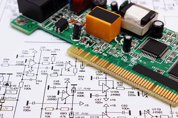 istock Printed circuit board lying on diagram of electronics, technology 504102686