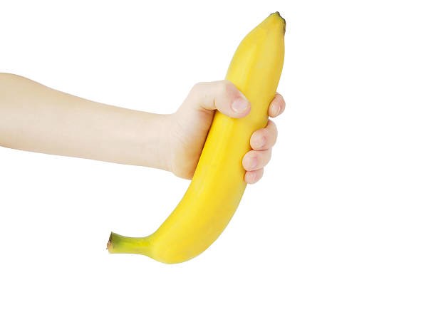 istock Ripe banana in hand boy, isolated 504102856