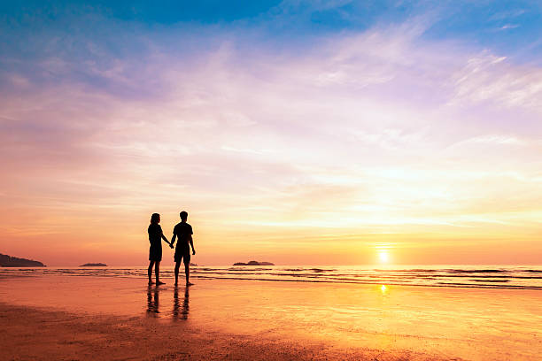 istock Two lovers standing together on a beach thinking about life 504102990