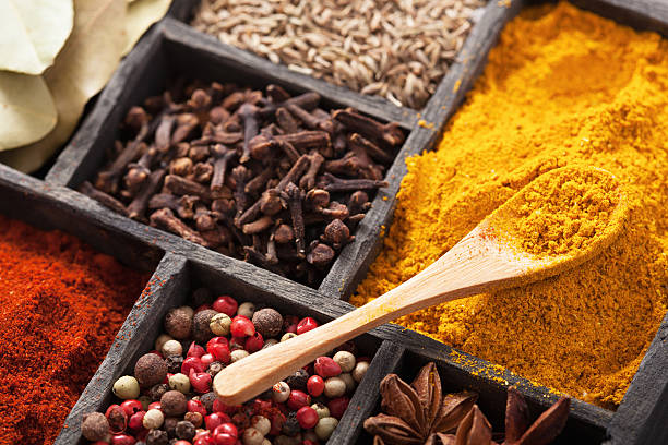 istock spices in box: pink black pepper, paprika powder, curry 504103191