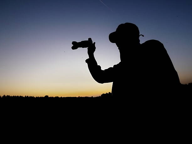 istock man photographing silhouette 504104077