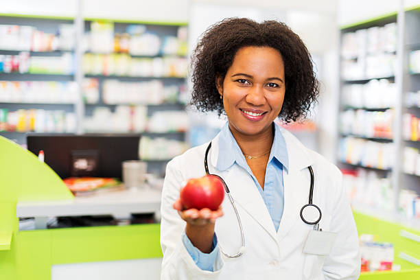 istock African American pharmacist holding apple. 504104147