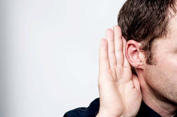 istock Man listening to gossip 504104157