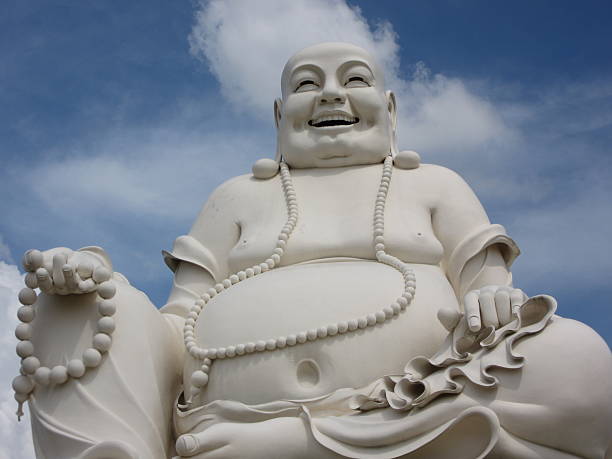 istock White Sitting Buddha Monument Against Blue Sky/Clouds 504105062