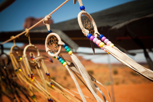 dream catchers against monument valley background. Indian jewellery in windy weather.