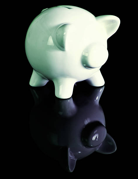 White ceramic piggybank reflected in black perspex A white ceramic piggybank is reflected in black perspex. Copy space under the piggy. perspex stock pictures, royalty-free photos & images