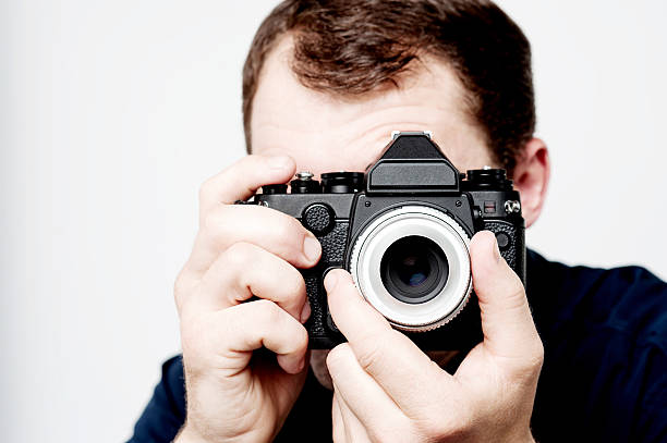 istock Man holding vintage camera, photographer 504105733