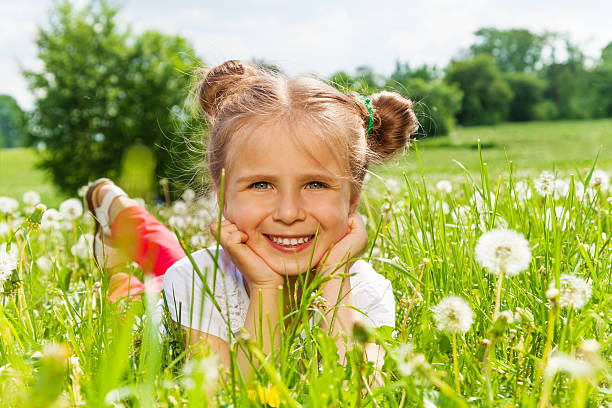 istock Nice girl smiles laying on a grass 504106823