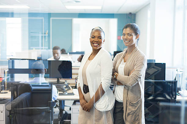 African business partners smiling, looking at the camera.