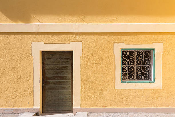 istock Yellow wall with door and window 504108042