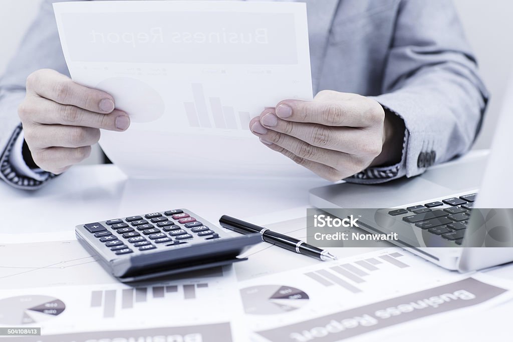 Businessman analyzing investment charts with laptop. Accounting Adult Stock Photo