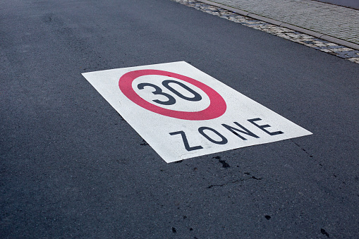Speed limit 30 painted on asphalt