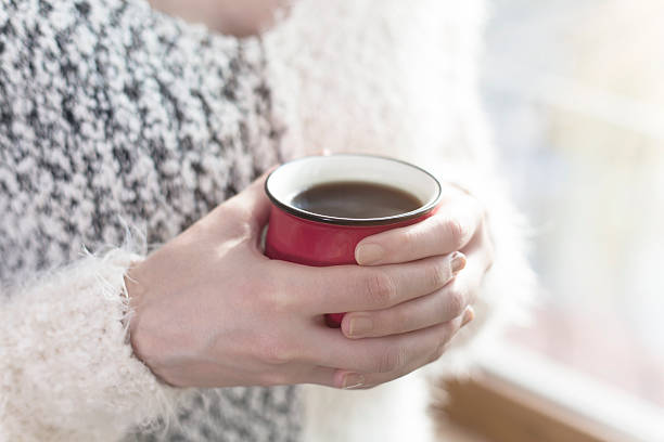 istock Girl hand in red coffee mug with glass front 504110110