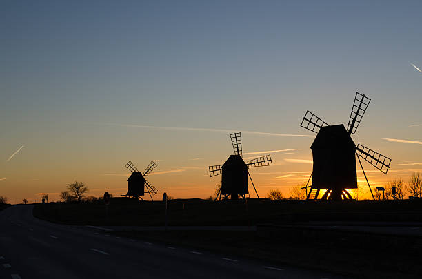 istock Windmills silhouettes by roadside at sunset 504110182
