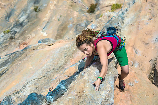 istock Young Rock Climber ascending steep colourful rocky Wall Lead Climbing 504112752