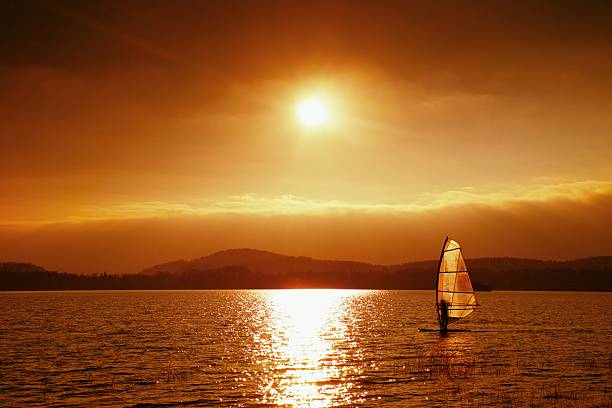 istock Windsurfer sailing into breeze Shot with gentle filter. Strongeflections. 504112946