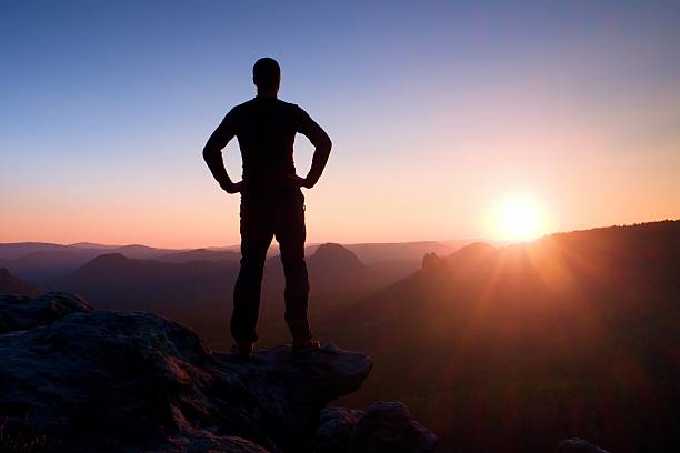istock Red daybreak. Slim tourist on  peak in rock empires park 504113806