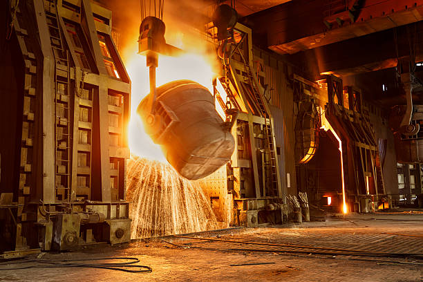 Metal smelting furnace in steel mills stock photo