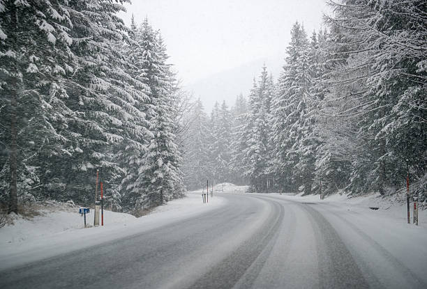 istock Curvy snow slush covered Winter Road, Unclear sight 504118616