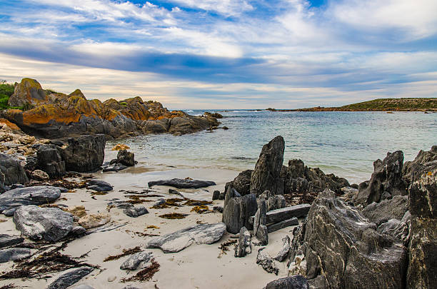 istock Vibrant orange coast line boulder rocks at the beach 504118926