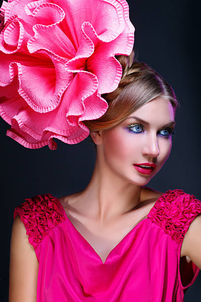 istock Girl with big pink flower on head 504125596