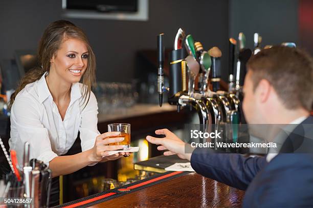 Beautiful Waitress Serving Handsome Businessman Stock Photo - Download Image Now - Bartender, Females, Whiskey